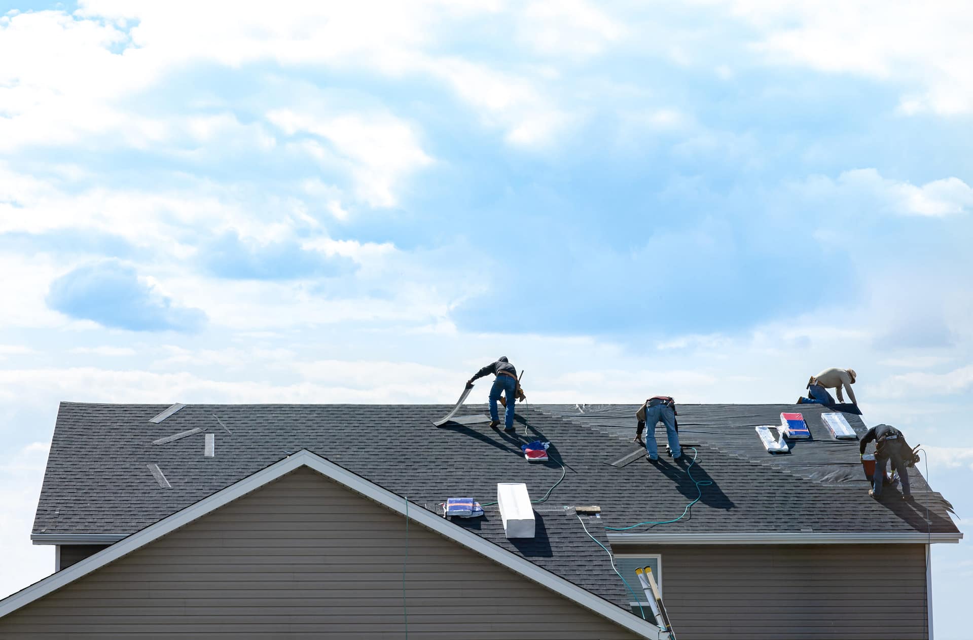 4 construction workers fixing roof against clouds blue sky, inst Roofers replace a roof, 4 men work on the job